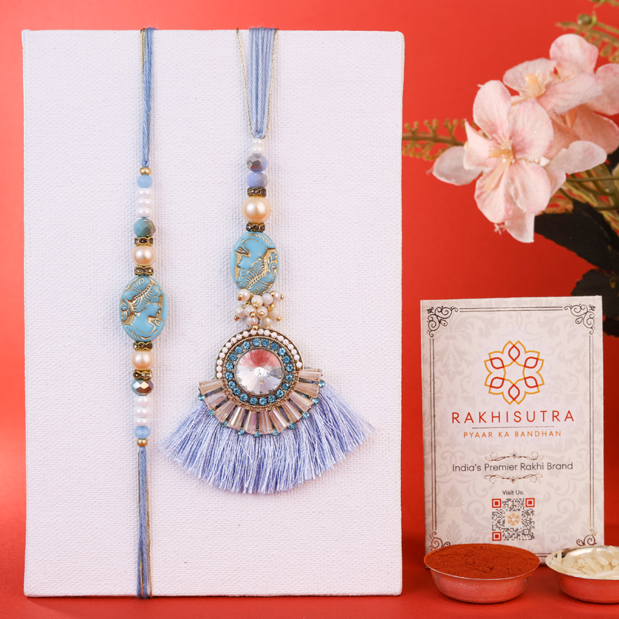 Exclusive Bhaiya Bhabi Rakhi Set featuring rakhis, Roli, Tika, Chawal, and a Message Card. 1