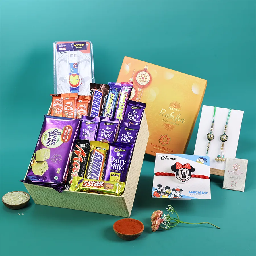 A vibrant family Rakhi gift box featuring traditional Rakhis and assorted chocolates. 1
