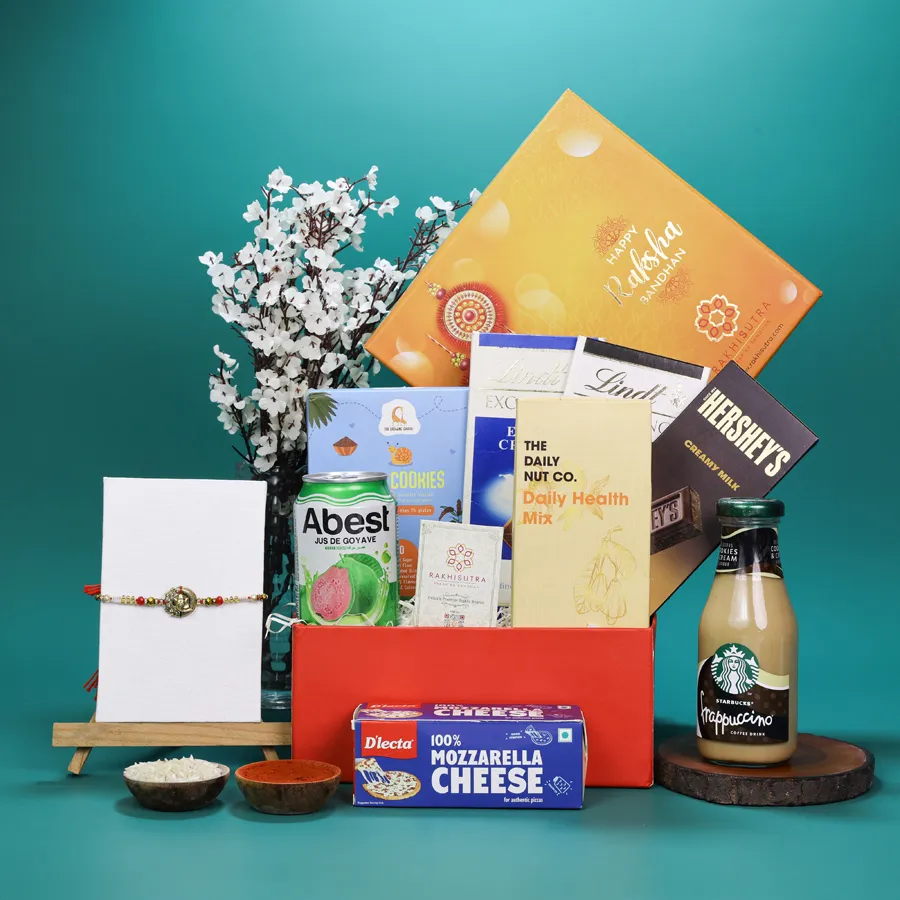 Premium Ganesh Rakhi with gourmet snacks in a gift box 1